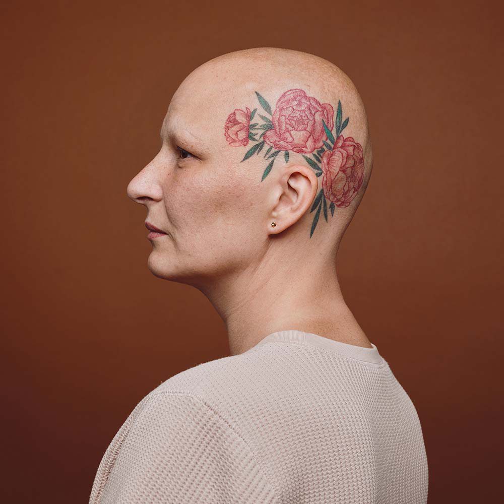 side-view-of-bald-woman-with-head-tattoo-7TJDCTZ.jpg